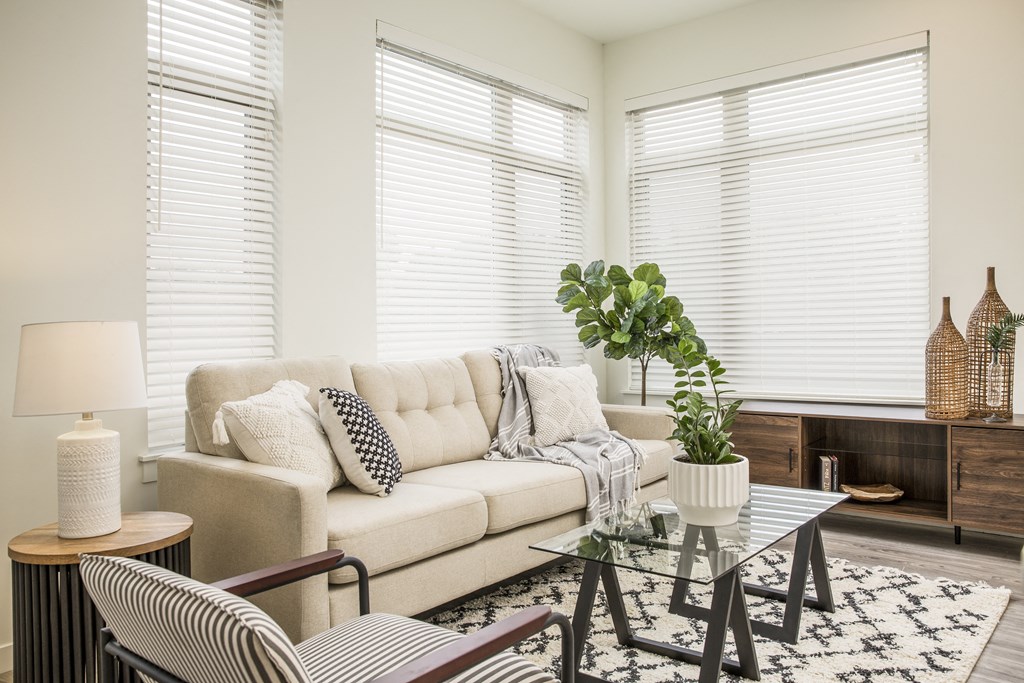 a living room with a couch and a glass table