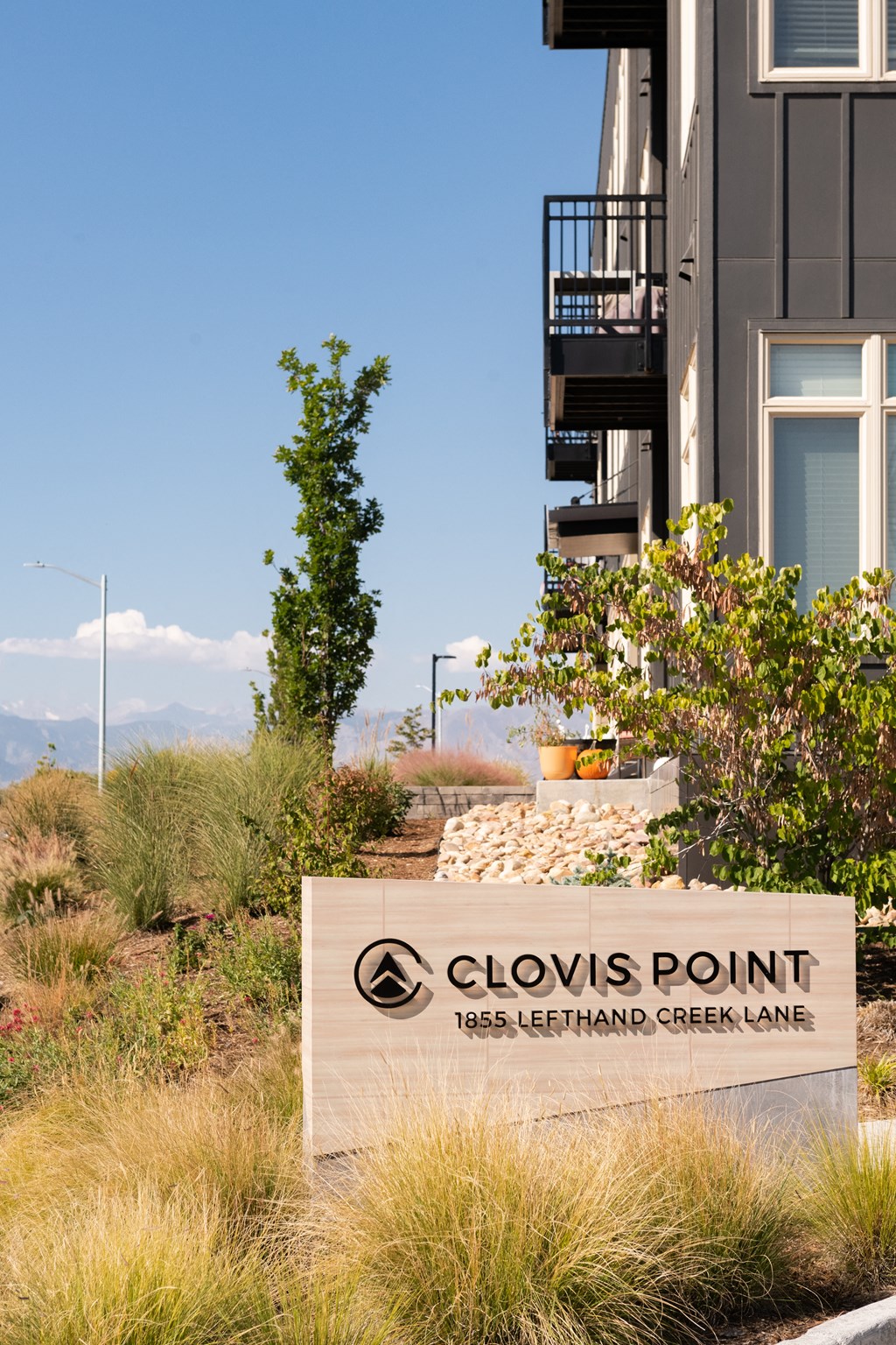 a sign that reads clovis point in front of a building