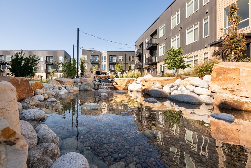 a water feature sits in front of a row of buildings