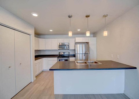 a kitchen with white cabinets and a counter top