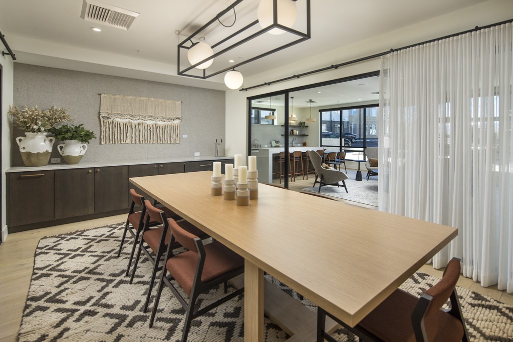 a dining room with a wooden table and chairs