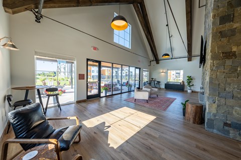 A room with a black leather chair and wooden floors. at Silverbrook Apartments, Kalispell