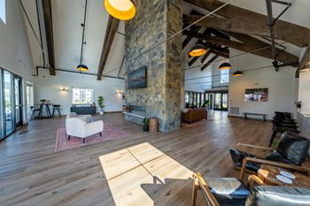 A living room with a stone pillar and wooden floors. at Silverbrook Apartments, Montana, 59901