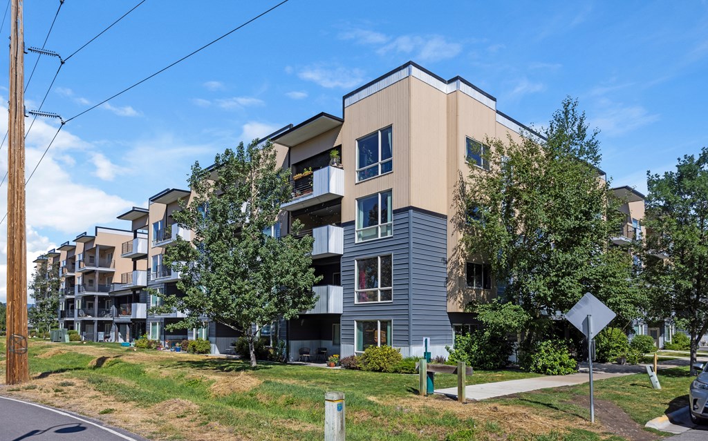 A modern apartment building with a mix of beige and grey exterior. at Ashlyn Place, Missoula, MT, 59801