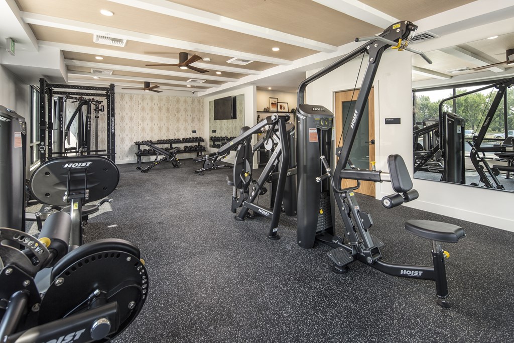 a gym with weights and other exercise equipment on the floor