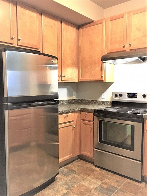 Kitchen appliances and cabinets at Ashlyn Place Apartments, Montana