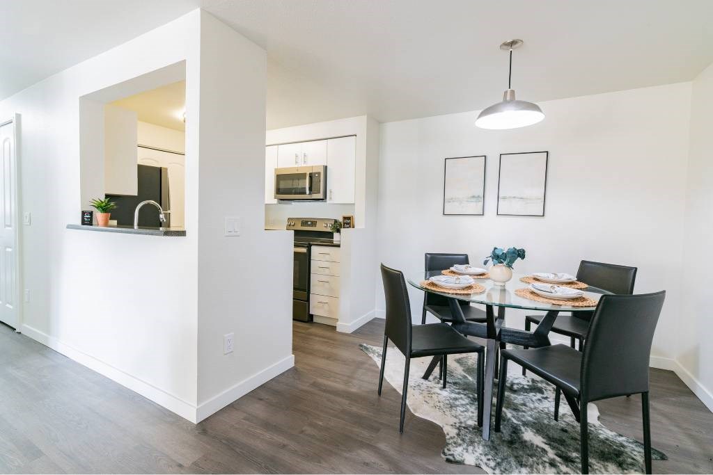 A modern dining room with a table set for two.