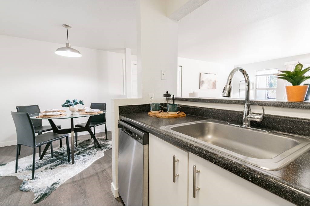 A modern kitchen with a dining table and chairs.