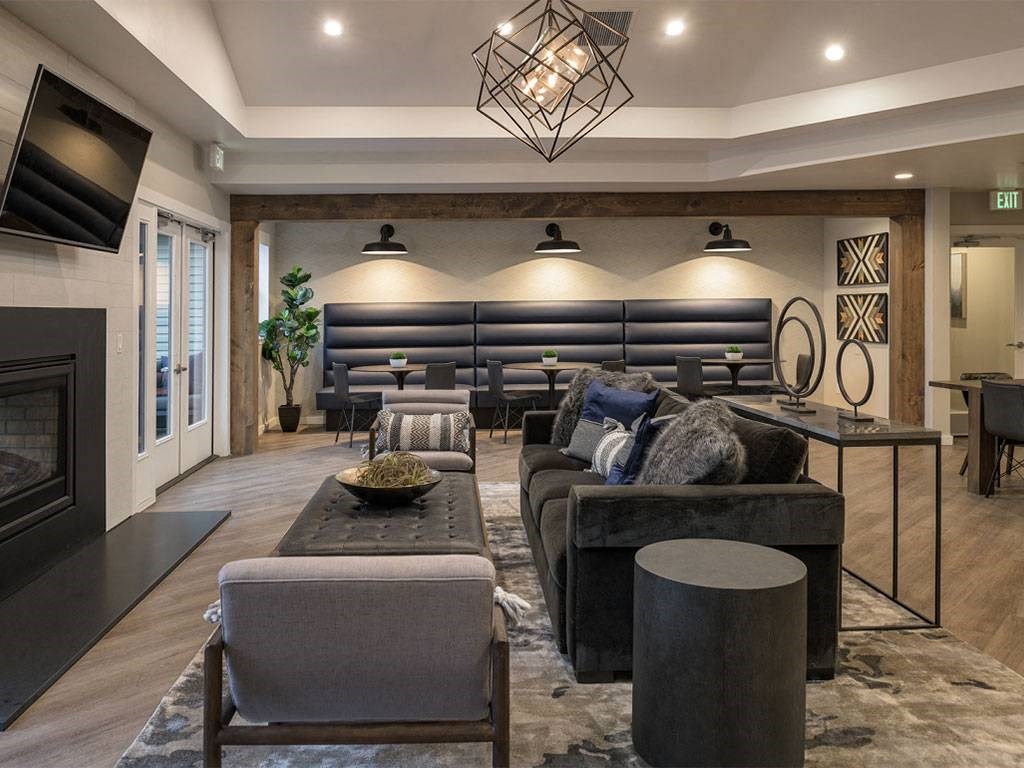 A modern living room with a fireplace and a large sofa.