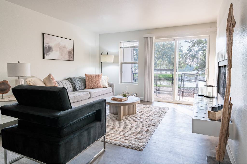 A living room with a black chair and a white couch.