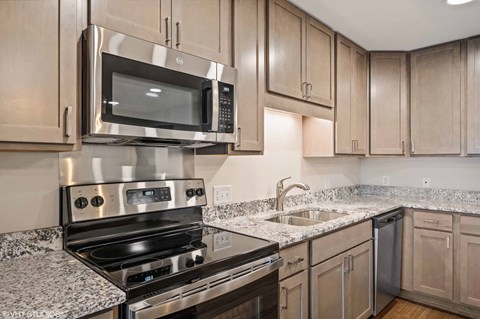 A modern kitchen with a stainless steel oven and microwave.