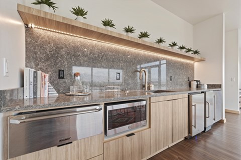 A modern kitchen with a stainless steel oven and wooden cabinets.