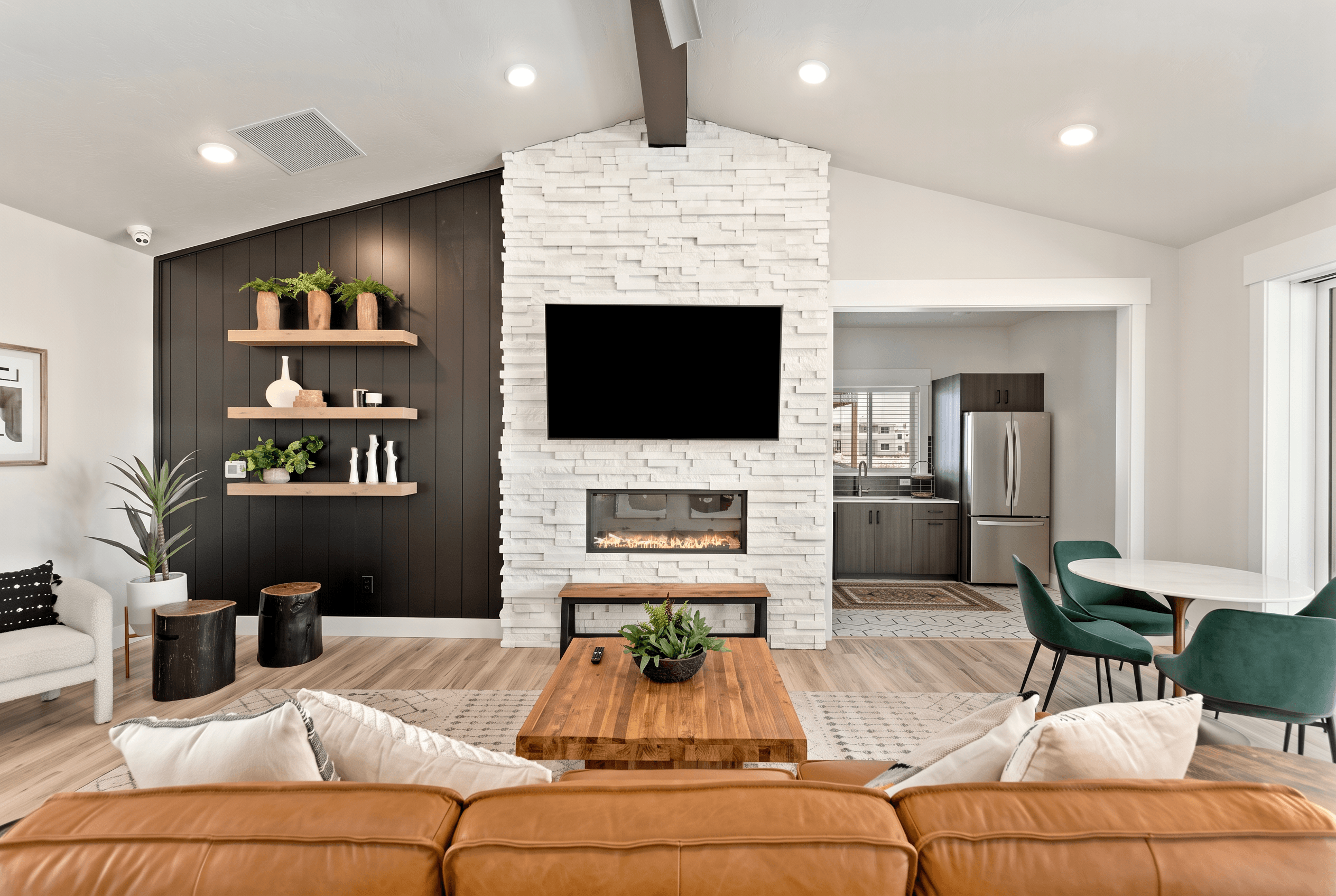 A modern living room with a fireplace and a television.