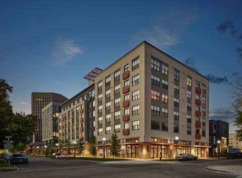 a large building on a city street at night at The Lucy Boise Apartments, Boise, 83702
