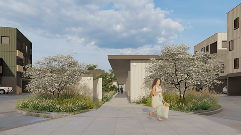 A woman in a white dress is walking down a sidewalk in front of a modern building.