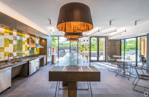 the kitchen and dining area of a modern house with a large table and chairs