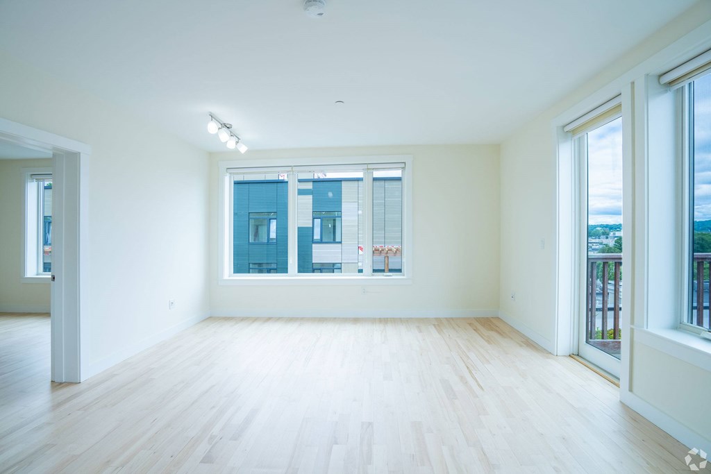 A large empty room with a window overlooking a cityscape. at 603 Concord Apartments, Cambridge 02138