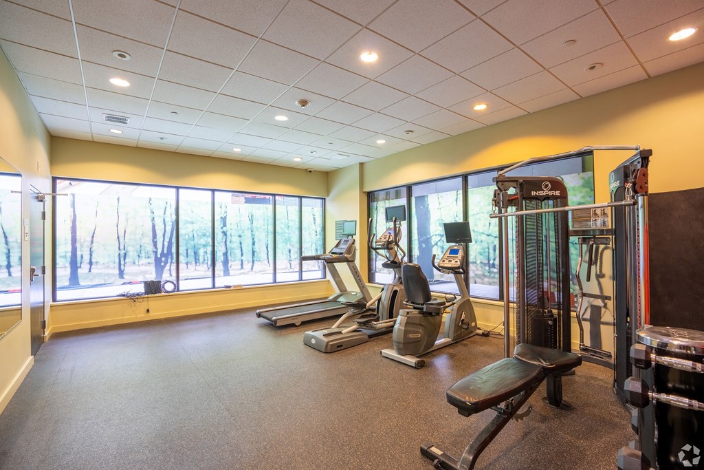 A gym with treadmills, exercise bikes, and weight machines at 603 Concord Apartments, Cambridge