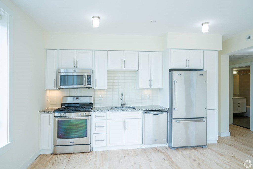 A kitchen with white cabinets and stainless steel appliances at 603 Concord Apartments, Cambridge, Massachusetts