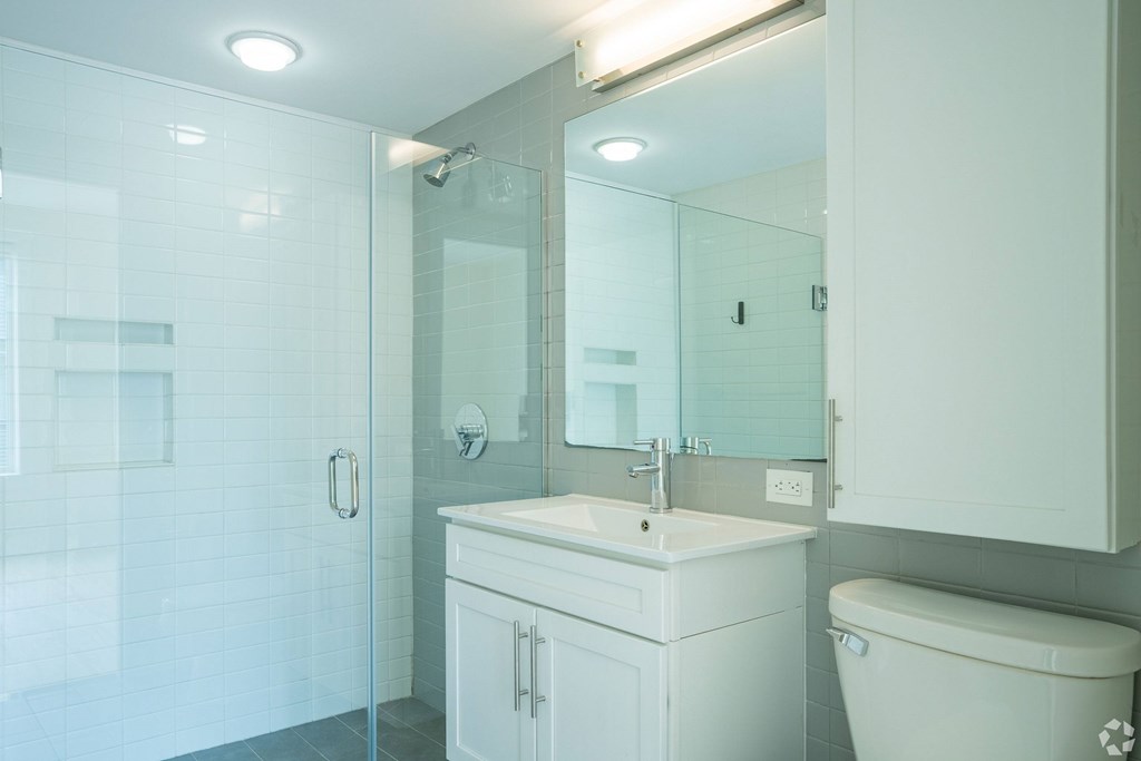 A white bathroom with a glass shower stall at 603 Concord Apartments, Cambridge, MA
