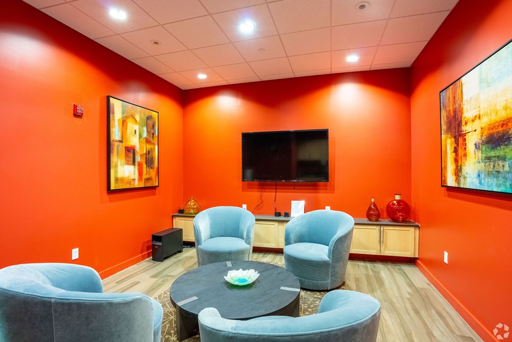 A living room with orange walls and a television at 603 Concord Apartments, Cambridge, MA, 02138