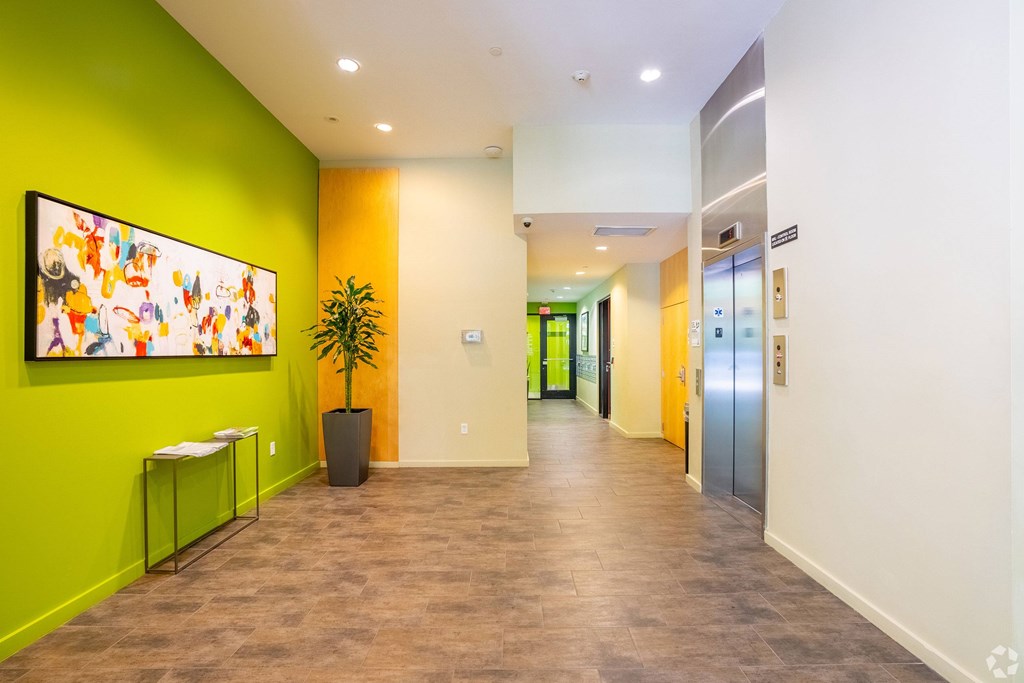 A hallway with a green wall and a painting on it at 603 Concord Apartments, Cambridge, MA
