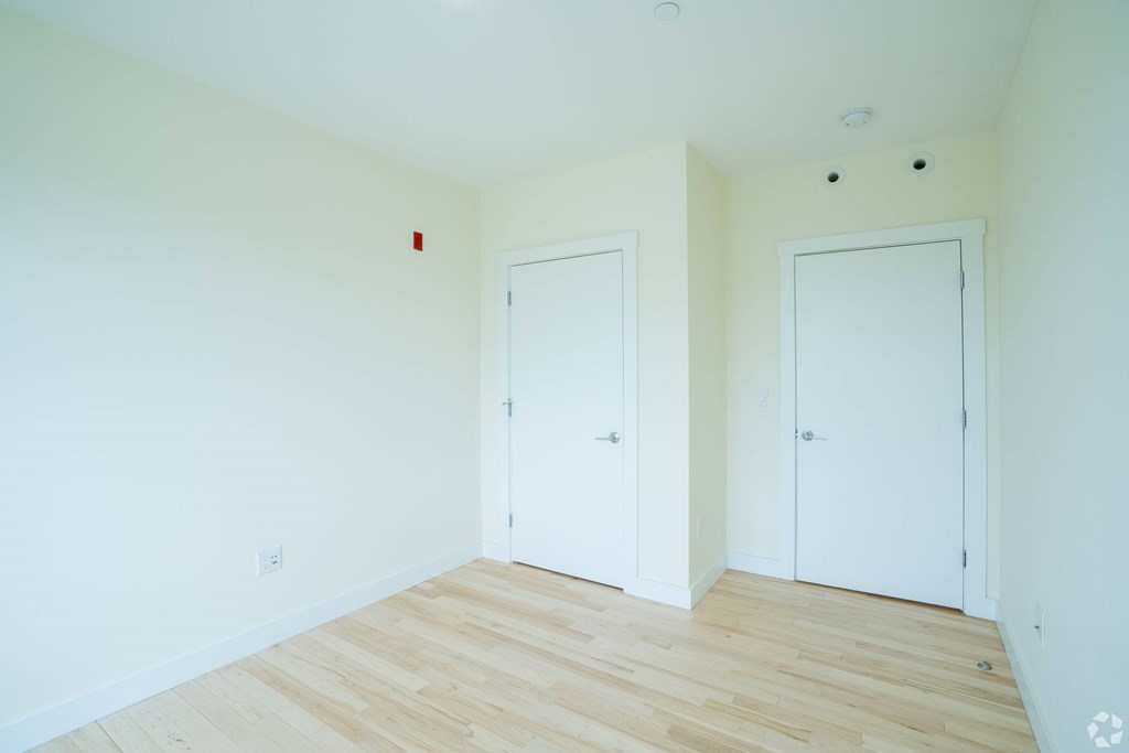 A room with two white doors and a wooden floor. at 603 Concord Apartments, Cambridge, Massachusetts