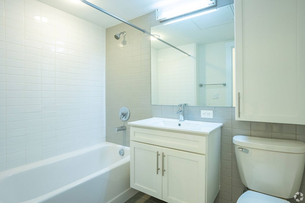 A white bathroom with a tub, sink, and toilet at 603 Concord Apartments, Cambridge 02138
