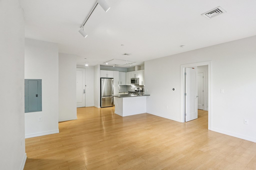 Unfurnished living room with kitchen view at Park77 Apartments, Cambridge, 02138