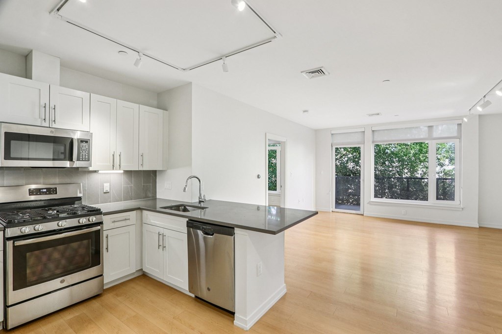 Kitchen with living room view at Park77 Apartments, Cambridge