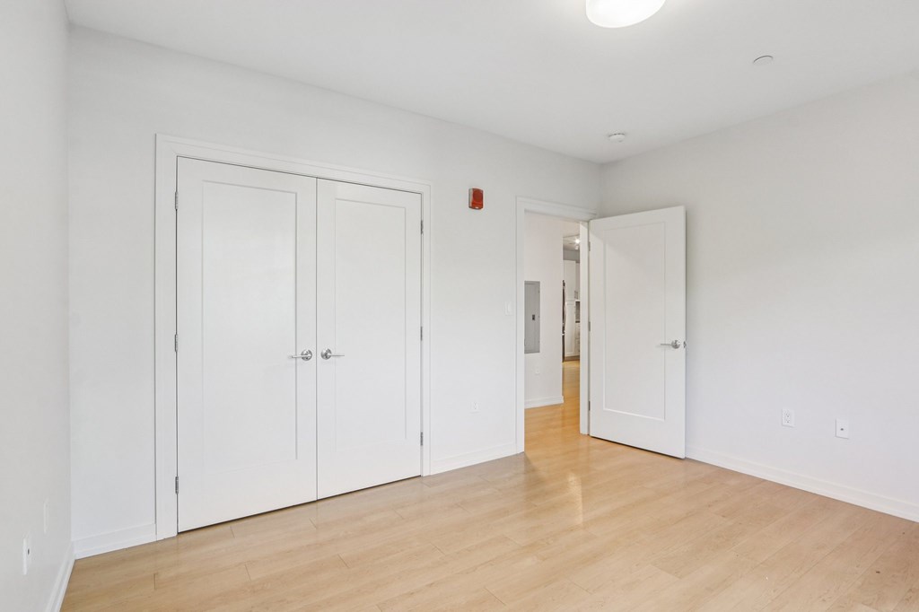 Spacious bedroom with wooden floor and closet at Park77 Apartments, Cambridge, MA