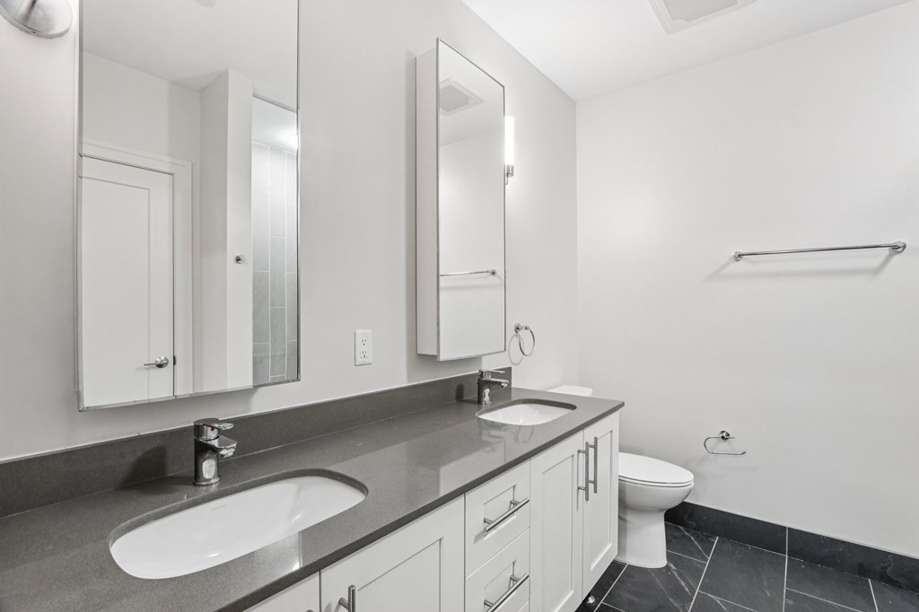 Bathroom with 2 sinks and mirrors and toilet at Park77 Apartments, Cambridge, Massachusetts, 02138