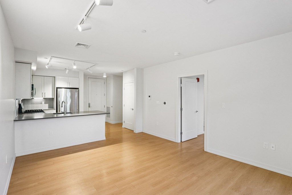 Spacious living room with kitchen view at Park77 Apartments, Cambridge, 02138