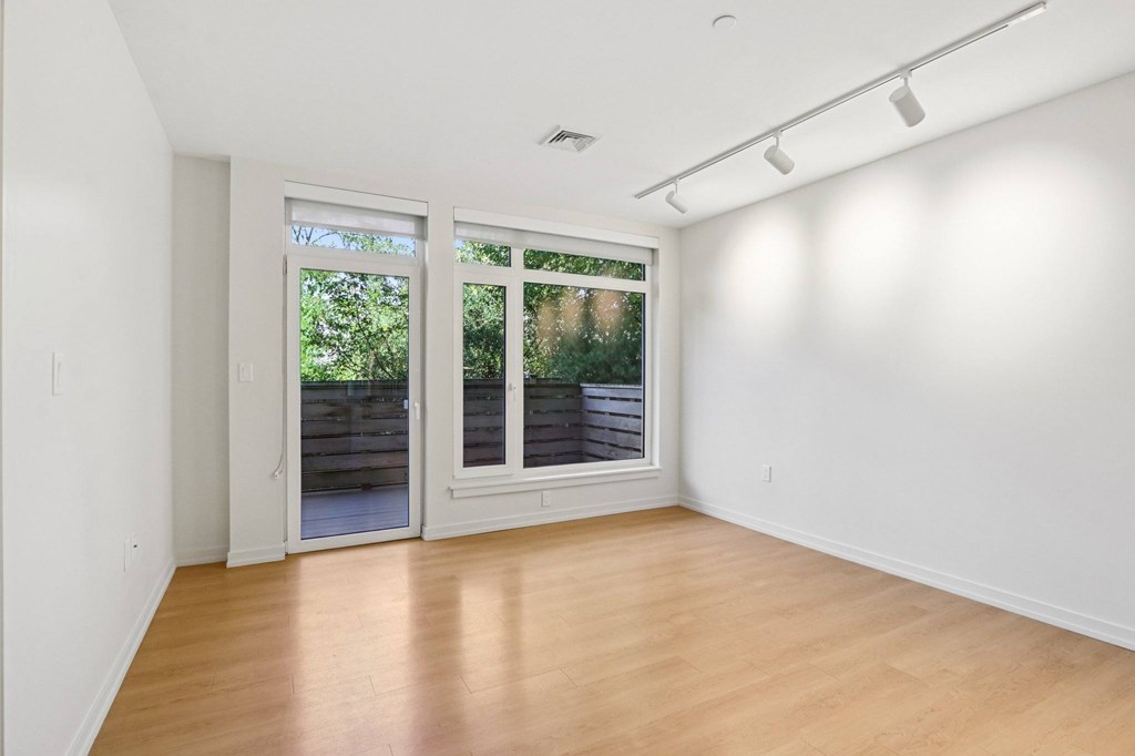 Living room with a sliding glass door at Park77 Apartments, Massachusetts