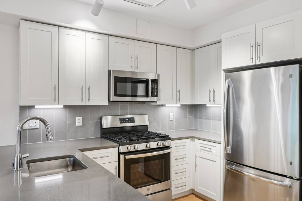 Modern kitchen with refrigerator at Park77 Apartments, Cambridge, Massachusetts