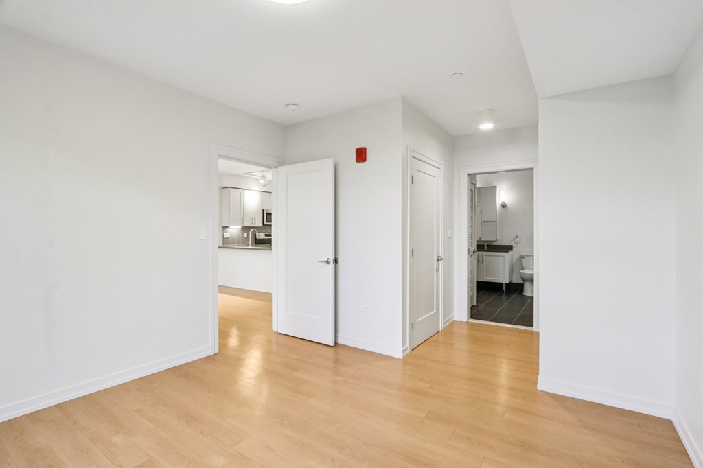 Bedroom with wooden floors and white walls  at Park77 Apartments, Cambridge, MA