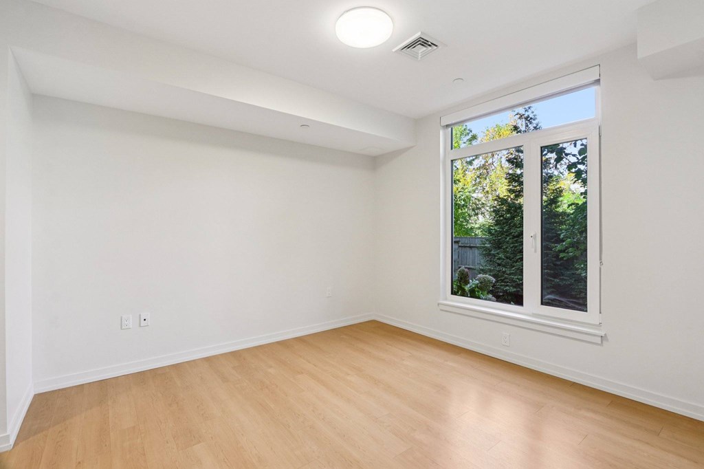 Bedroom with a window at Park77 Apartments, Cambridge