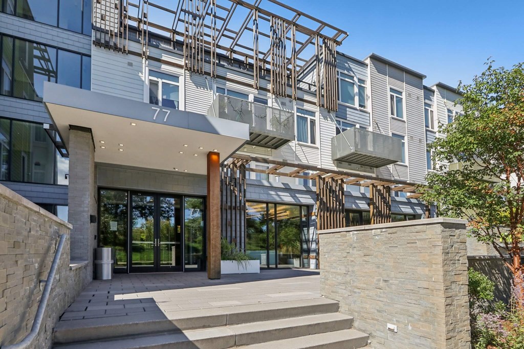 Modern building with a glass facade and a stone entrance at Park77 Apartments, Cambridge, Massachusetts, 02138