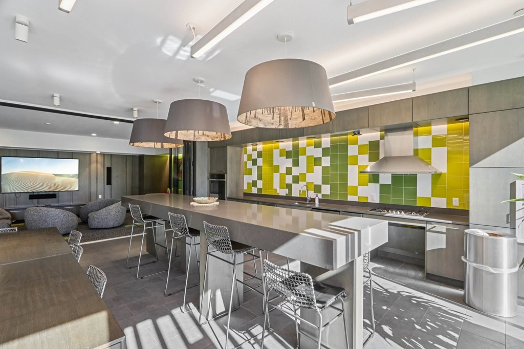 Modern kitchen with a yellow and green tiled backsplash at Park77 Apartments, Cambridge, MA, 02138