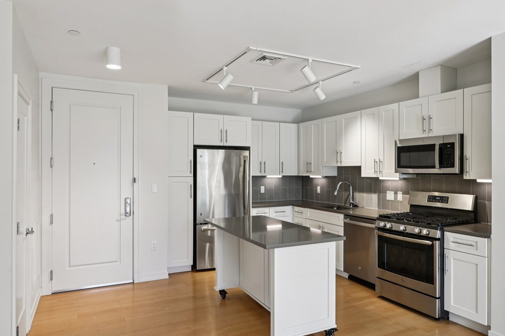 Beautifully decorated kitchen with white furniture at Park77 Apartments, Cambridge, 02138