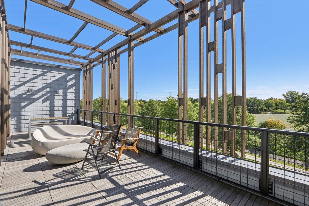 Wooden deck with a metal railing and a chair at Park77 Apartments, Cambridge, Massachusetts