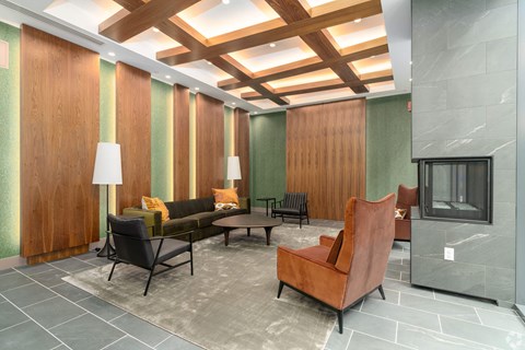 A living room with a brown chair and a grey sofa.