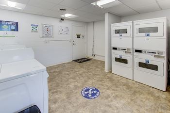 A laundry room with washers and dryers.