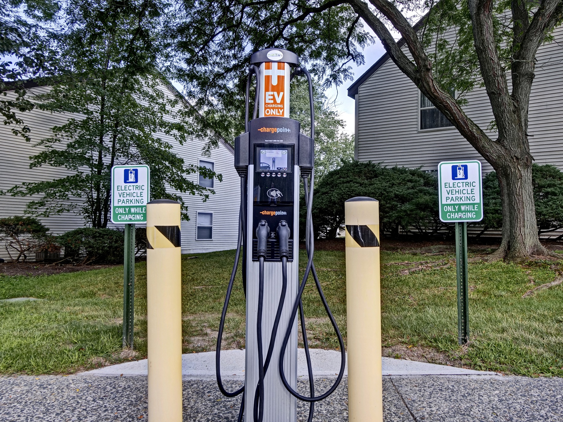 a gas pump sitting in the middle of three poles