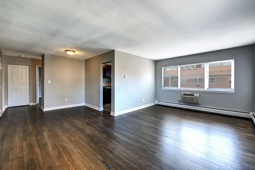 a living room with hardwood floors and grey walls