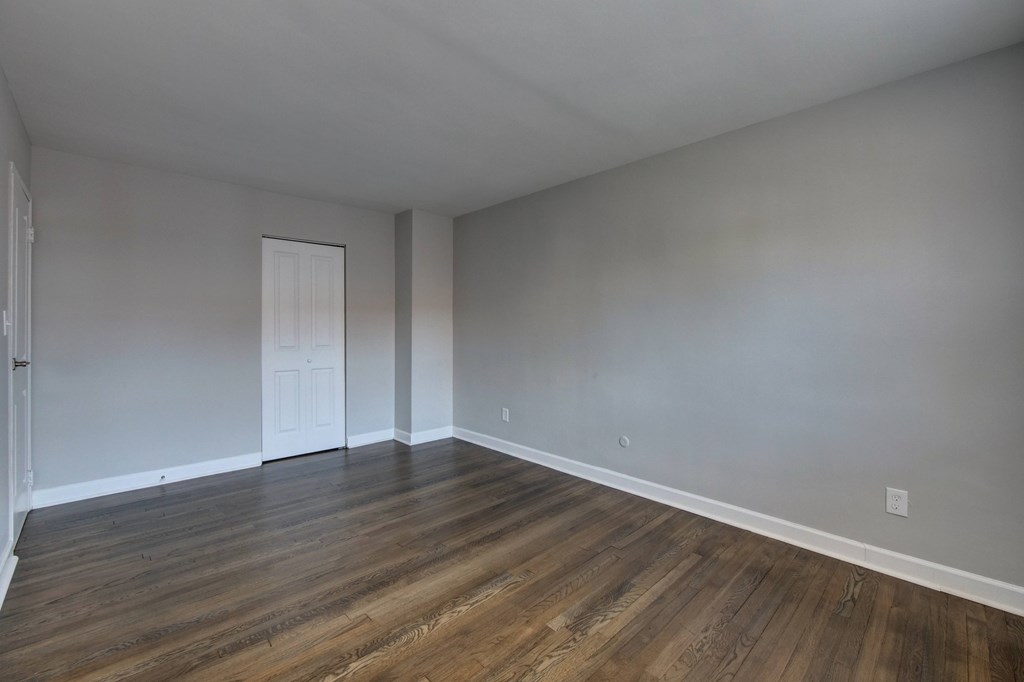 A room with wooden floors and a white door.