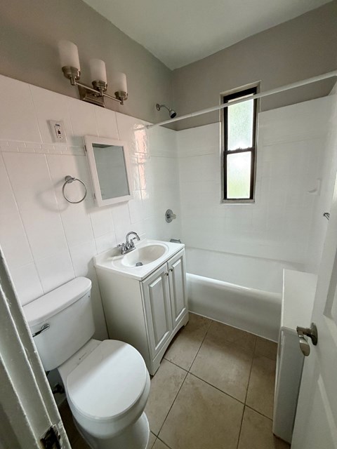 A white toilet and sink in a small bathroom.