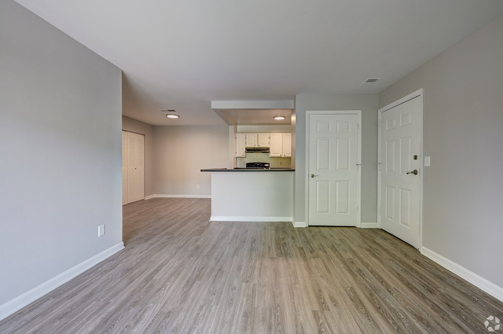 an empty living room and kitchen in a new home