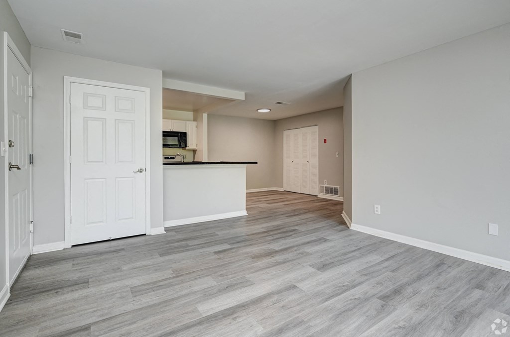 an empty living room and kitchen in a new home
