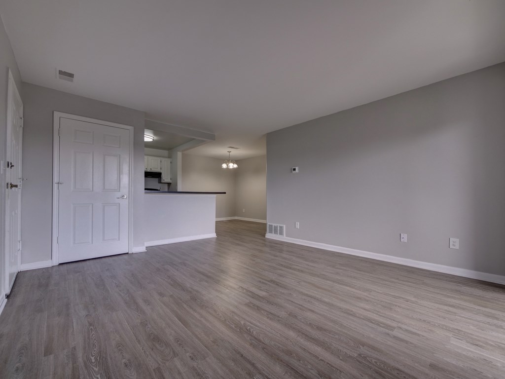 an empty living room and kitchen in a new home
